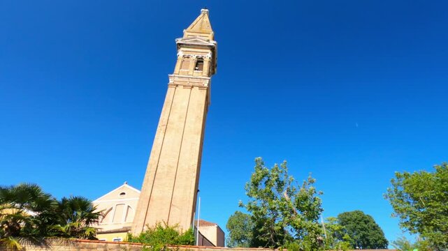 PAN SLOW - The leaning bell tower on the island of Burano in the Venice lagoon, Italy. Because of land subsidence it is inclined of 1.83 meters respect to its axis.