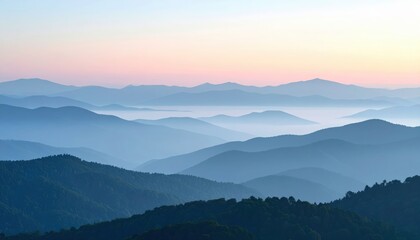 Fototapeta premium Misty mountain ranges at sunrise with soft pink and blue hues and dense forest in foreground