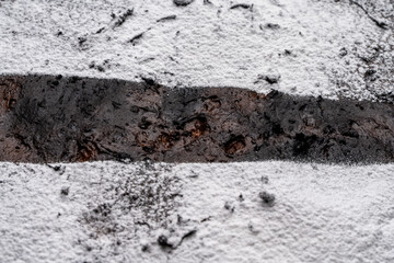 Fototapeta premium Flan, a traditional French dessert on a metal black grill on a white table.