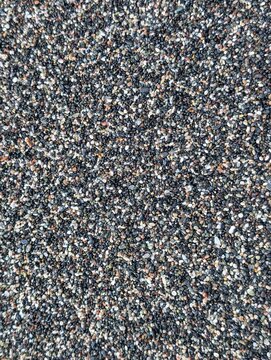 Detailled picture of black sand of a beach in greece