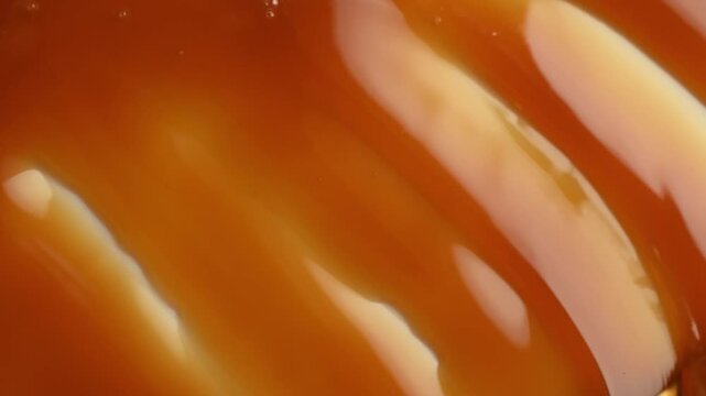 Close-up of sweet caramel sauce texture and smearing