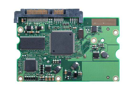 Printed circuit board, PCB of a hard disk drive, HDD, from above. Flat piece of layered fiberglass with copper traces, memory, and and support chips, to be mounted to the exterior of the device. Photo