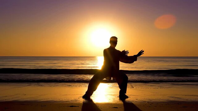 Peaceful sunset silhouette of person practicing tai chi on beach with ocean waves. Tranquil moments at sunset include graceful tai chi movements enhancing relaxation and mindfulness.