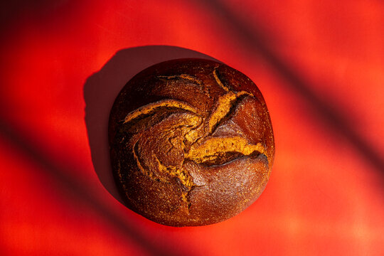 Artfully crafted bread on vibrant red background