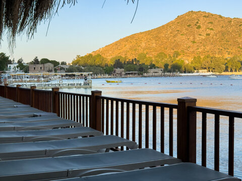 Relaxing summer seaside view with lounge chairs