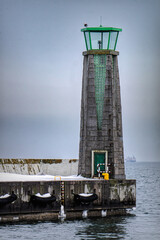 Fototapeta premium Cold winter weather in Europe. Lighthouse and pier in Gdynia 