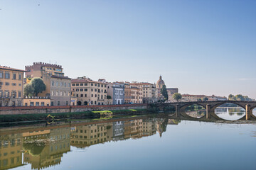 Fototapeta premium Famous historic Ponte Vecchio bridge and old buildings along the Arno river in Florence Italy