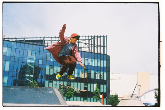 Skater performs a frontside ollie in an urban skatepark