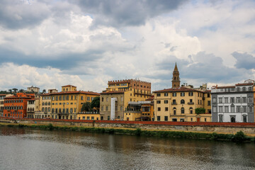 Obraz premium Famous historic Ponte Vecchio bridge and old buildings along the Arno river in Florence Italy