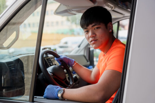 Paramedic wearing gloves driving ambulance car