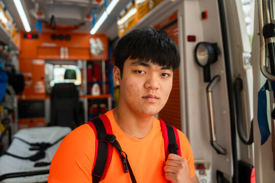 paramedic posing inside ambulance ready for emergency