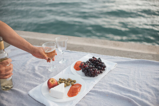 Point of view of a woman hands eating at a picnic
