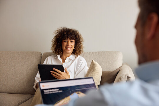 Woman converses with a colleague in a hotel room