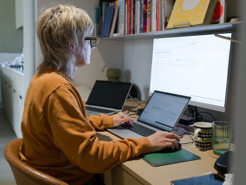 Working on Multiple Screens in a Modern Home Office Setting