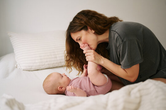 Mother plays with her infant at home