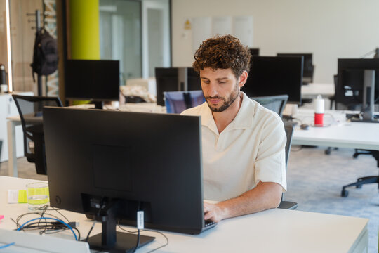Man works on a desktop computer at the office