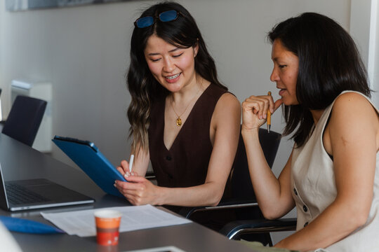 Women discussing work matters in the office