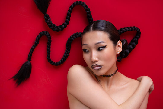 Woman with trendy fashion braids hairstyle studio fashion portrait