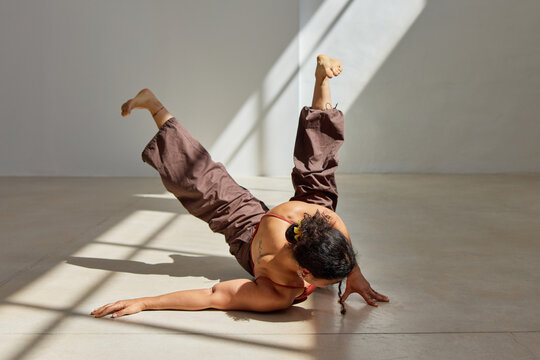 Dancer showcases modern choreography in bright studio setting