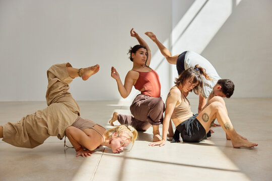 Group of dancers performing contemporary choreography in studio