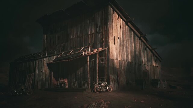 A rustic wooden barn stands prominently, its weathered exterior catching the fading light, surrounded by a dusty dirt road and motorcycles, creating an evocative rural atmosphere.