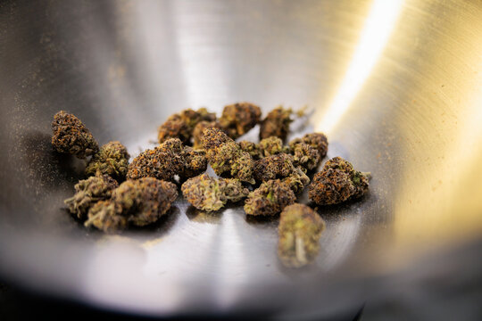 Cannabis buds in a metal bowl.