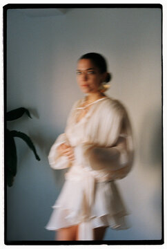 Woman posing in silk dress and motion blur