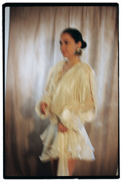 Motion blur portrait of woman wearing stylish dress