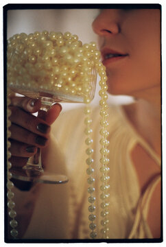 Woman drinking beverage made from white pearls