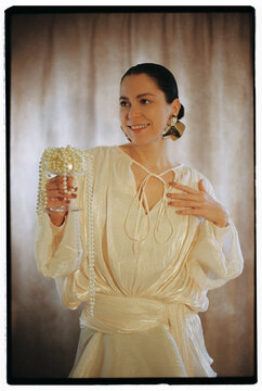 Glamorous woman enjoying drink at party. Conceptual photo