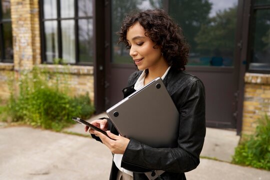 Real estate agent waiting for clients in front of an object for sale 