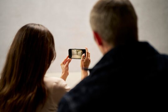 Potential buyer couple takes pictures in a German property