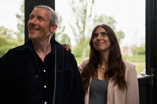 Couple Enjoying a Joyful Moment Indoors on a Cloudy Day