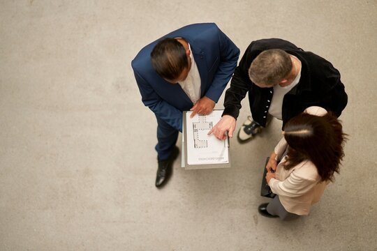 Group Discusses Property Project Plans in Modern Office Setting