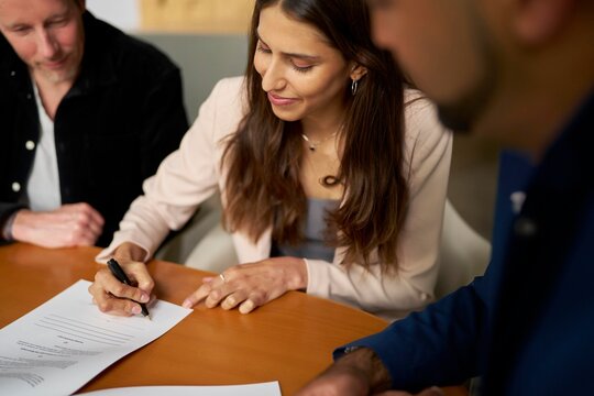 Group Meeting for Contract Signing in a Modern Office Setting