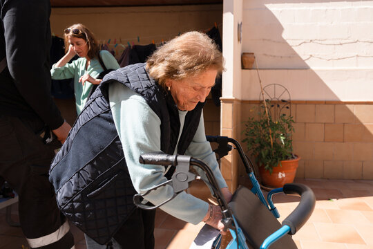 Elderly woman adjusting her walker