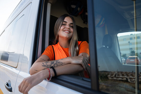 Paramedic smiling from ambulance window during break time