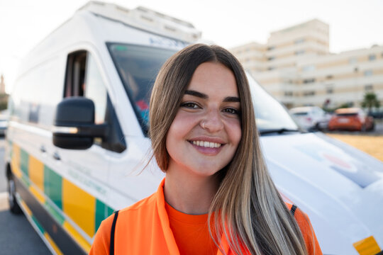 Paramedic smiling near ambulance in the city