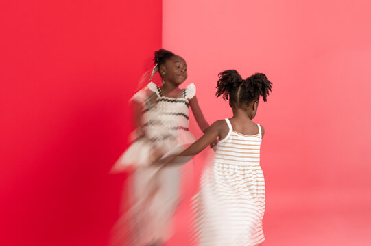 Sisters spinning and holding hands