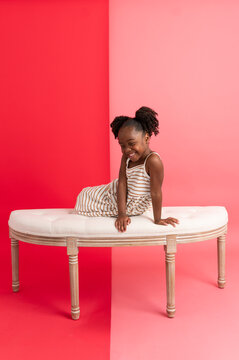 Wide angle girl posing on stool