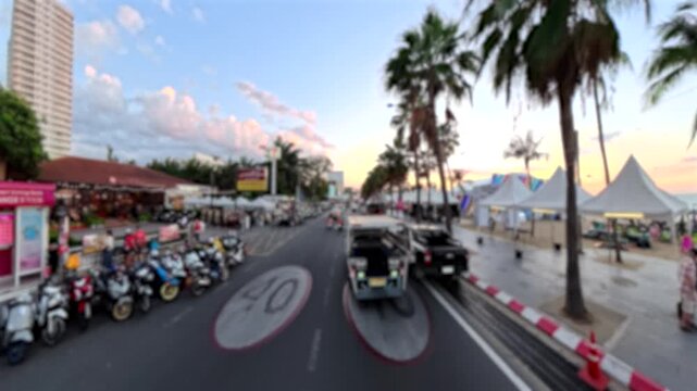 PATTAYA, THAILAND - DEC 2025 : Aerial high angle driving view of Pattaya beach road and sea in sunset. Travel, tourism and beach vacation concept video.
