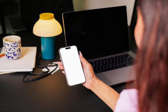 Woman with Phone with white screen mockup in Work Setup