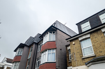 A street view of residential properties in various architectural styles in a London suburb.