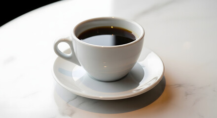 Obraz premium Black coffee in a white ceramic cup and saucer on a marble surface, ready for a quiet morning or a refreshing break