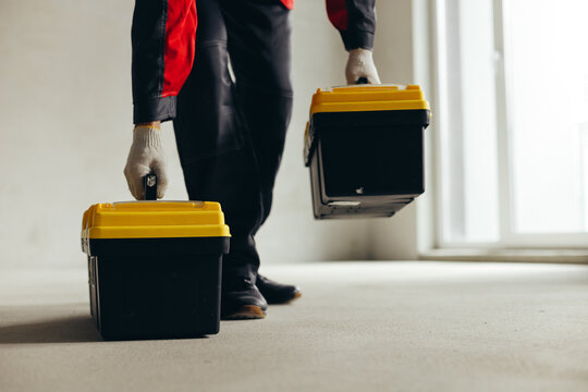 Hand Lifting Tool Case By Handle Above Concrete Floor.