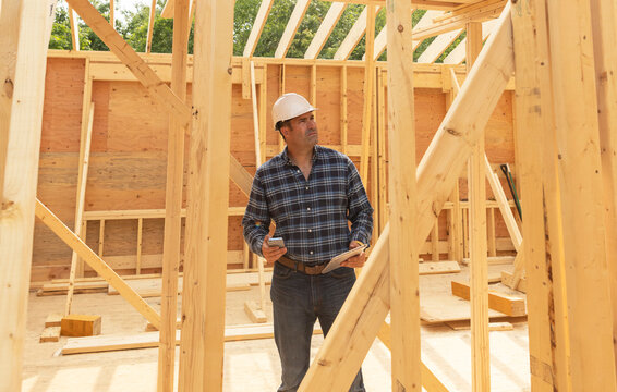 House Construction  builder holding cell phone 