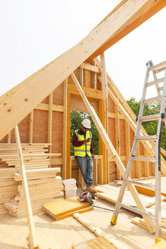 Construction worker break texting on cell phone 