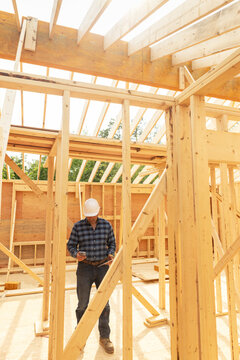 Home Construction Site builder texting cell phone 
