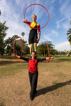Performance With Hula Hoops in Park by Skillful Artists