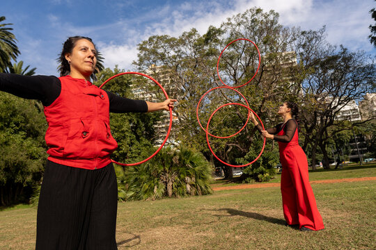 Performers Showcase Hoop Dancing in a Vibrant Park Setting